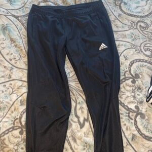 All black adidas joggers with lower leg zip